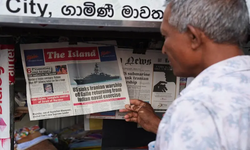 A man in Galle reads about a submarine attack on an Iranian military ship off the coast of Sri Lanka on Thursday. &ndash; Reuters