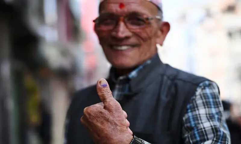 A man shows the ink mark on his thumb after voting during the general election in Kathmandu, Nepal. &ndash; Reuters