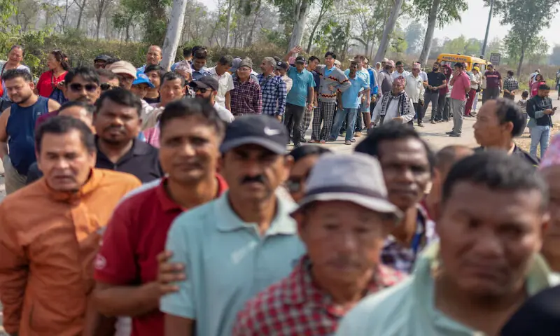 People stand in a queue outside a polling station as they wait for their turn to vote at a village, in Jhapa district, Nepal. &ndash; Reuters