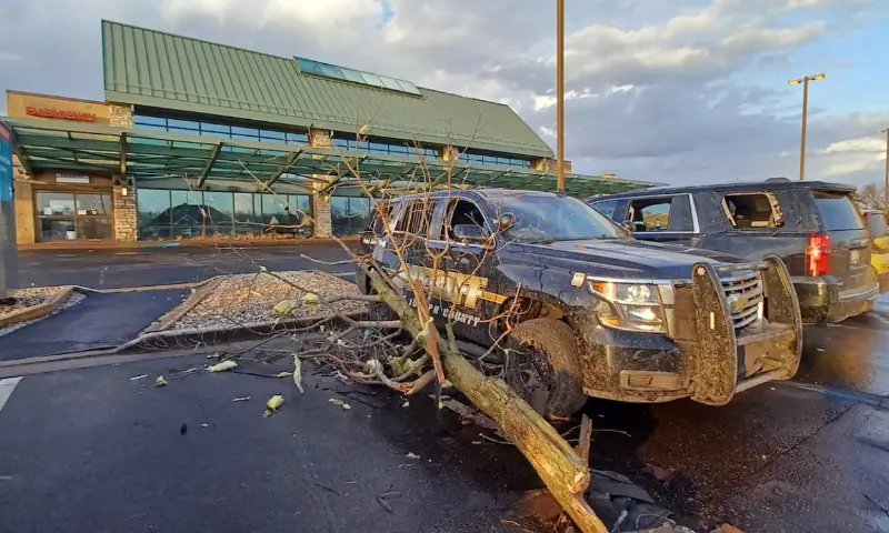 A fallen tree rests against a Sheriff&rsquo;s vehicle outside a hospital following storms and tornado warnings in Three Rivers, Michigan, US. &ndash; Reuters