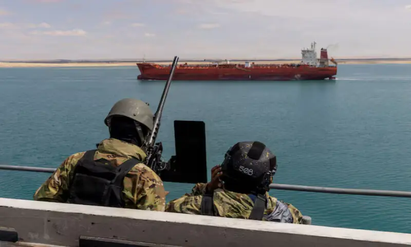 US navy sailors stand small craft action team watch on a catwalk of the aircraft carrier USS Gerald R. Ford as it transits the Suez Canal in Egypt. &ndash; Reuters