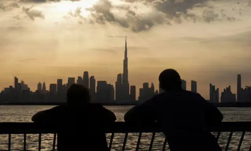 People watch the sunset over Dubai, with a general view of the Dubai skyline, including Burj Khalifa, centre, amid the U.S.-Israel conflict with Iran. &ndash; Reuters