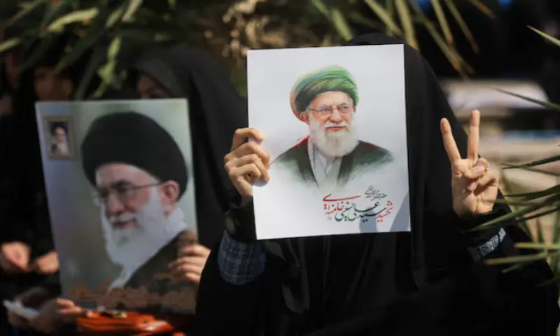 A woman gestures while holding an image of Iran&rsquo;s late Supreme Leader Ayatollah Ali Khamenei, on the day of an anti-Israeli and US rally in Tehran, Iran. &ndash; Reuters