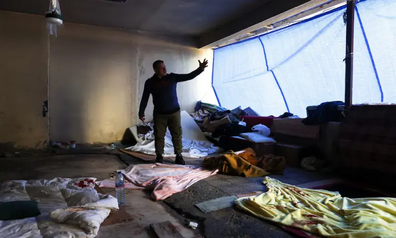 Bilal, who was staying with his children at the Ramada Plaza hotel building during an Israeli strike, gestures as he stands amid bloodstained belongings after his children were injured in the strike in central Beirut, Lebanon. &ndash; Reuters