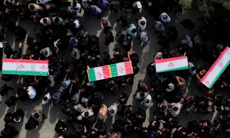 People carry coffins as they attend the funeral of the victims following an Israeli strike on a school, amid the U.S.-Israeli conflict with Iran, in Minab, Iran. &ndash; Reuters