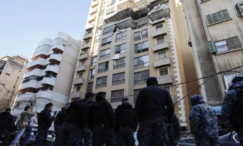 Emergency personnel stand near a damaged apartment building in the aftermath of an Israeli strike, in central Beirut, Lebanon, &ndash; Reuters