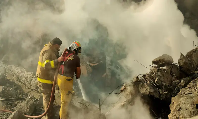Members of the Lebanese Civil Defence work to extinguish a fire in a building destroyed after an Israeli strike on Beirut&rsquo;s southern suburbs. &ndash; Reuters