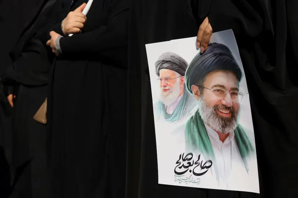 A woman holds an image of Iran&rsquo;s new supreme leader, Mojtaba Khamenei, alongside late Supreme Leader Ayatollah Ali Khamenei, during a funeral ceremony for the Iranian military commanders who were killed in the US-Israeli strikes. &ndash; Reuters