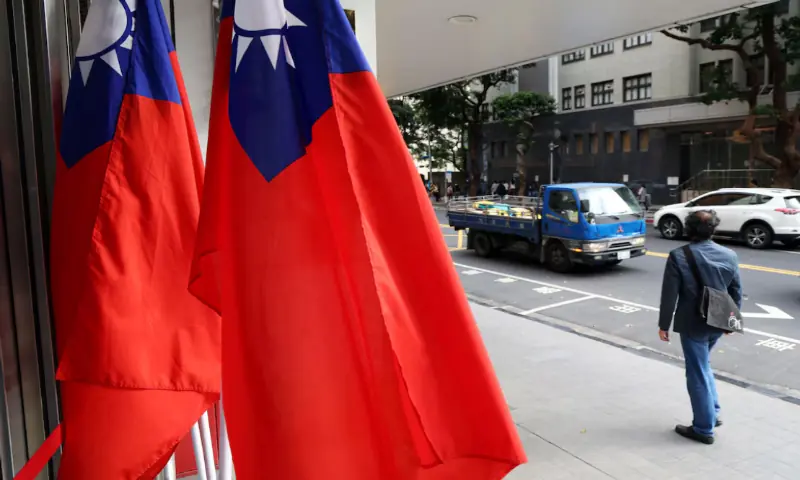 A man walks past Taiwan flags on a street amid China&rsquo;s &ldquo;Justice Mission 2025&rdquo; military drills around Taiwan. &ndash; Reuters