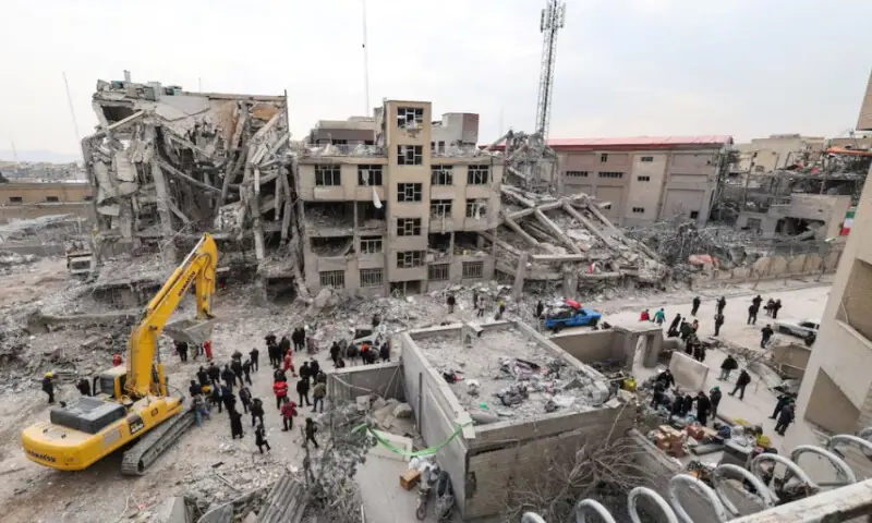 People gather at the site of an airstrike, amid the U.S.-Israeli conflict with Iran, in Tehran, Iran, on March 12, 2026. Reuters