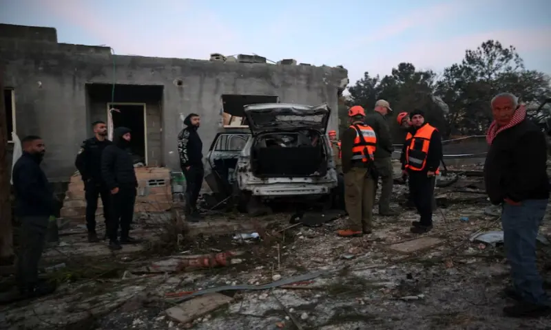 Israeli emergency responders and people gather at the site of an impact by an Iranian missile, amid the U.S.-Israel conflict with Iran, in northern Israel, on March 13, 2026. Reuters