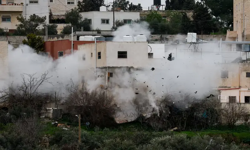 Smoke rises as the Israeli army demolishes a Palestinian house in Dura, in the Israeli-occupied West Bank. &ndash; Reuters
