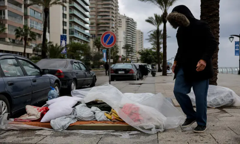 A displaced man stands next to a makeshift bed at the corniche in Beirut after rainfall following Israeli strikes in Beirut, Lebanon, on Sunday. – Reuters A displaced man stands next to a makeshift bed at the corniche in Beirut after rainfall following Israeli strikes in Beirut, Lebanon, on Sunday. – Reuters