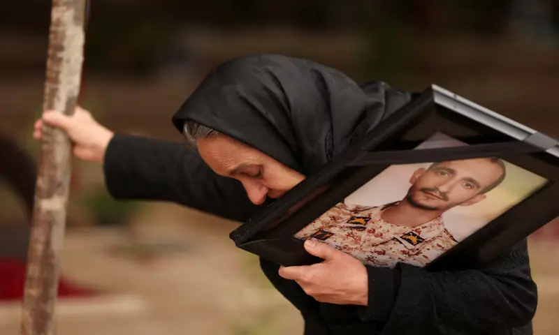 Marzia Rezaei reacts while standing near the grave of her son, Erfan, who was killed in strikes, amid the U.S.-Israeli conflict with Iran, at Behesht-e Zahra cemetery, in Tehran, Iran. &ndash; Reuters