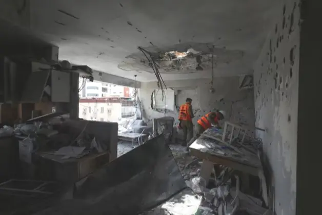 Soldiers inspect the remains of an apartment that was struck in a deadly Iranian missile attack, amid the U.S.-Israeli conflict with Iran, in Ramat Gan, Israel, on March 18, 2026. Reuters file