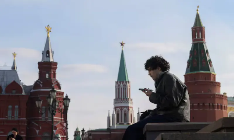 A man checks his mobile phone in central Moscow, Russia. &ndash; Reuters
