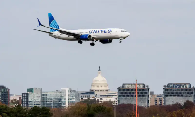 A United Airlines flight lands in the US Capitol at Ronald Reagan Washington National Airport as the Trump administration warns of impending cuts to commercial airline operations more than a month into the continuing US government shutdown in Arlington, Virginia, US. &ndash; Reuters