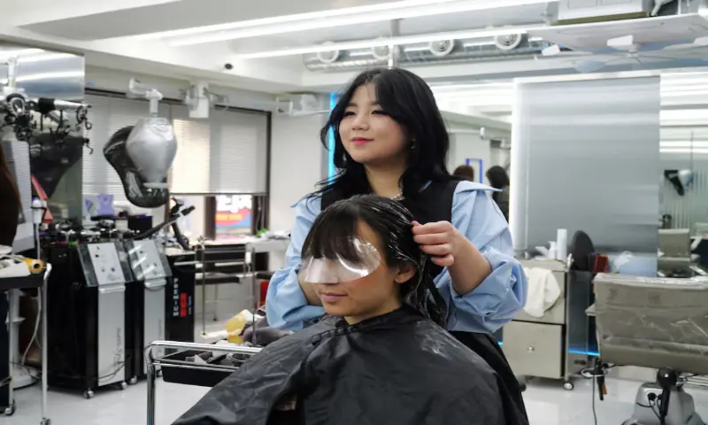 Marie Anne Stotz, a French fan of K-pop group BTS, gets a perm at a hair salon in Seoul, South Korea. &ndash; Reuters