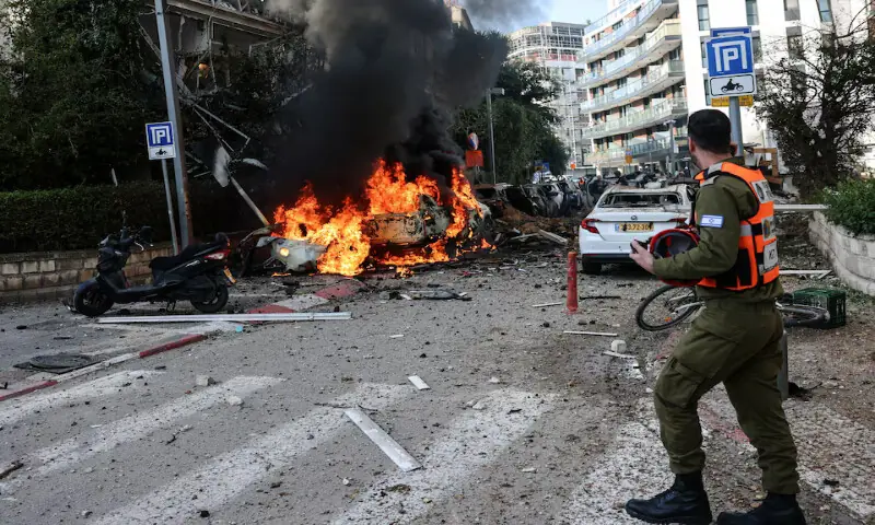 An emergency worker walks at a site following Iranian missile barrages in central Israel in Tel Aviv, Israel on Tuesday. &ndash; Reuters