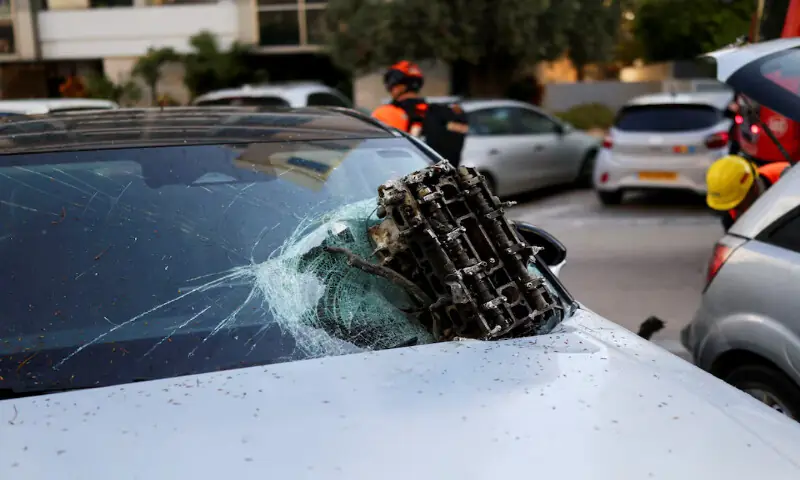 A piece of debris lies on a destroyed car at the site following Iranian missile barrages in central Israel in Tel Aviv, Israel, on Tuesday. &ndash; Reuters