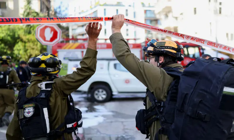 Emergency personnel work at the site following Iranian missile barrages in central Israel in Tel Aviv, Israel, on Tuesday. &ndash; Reuters