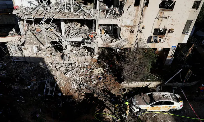 Emergency personnel work at the site following Iranian missile barrages in central Israel in Tel Aviv, Israel, on Tuesday. &ndash; Reuters