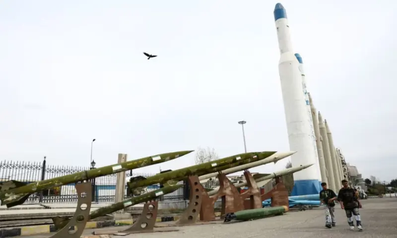 People walk near Iranian missiles in a park, amid the U.S.-Israeli conflict with Iran, in Tehran, Iran, on March 26, 2026. Reuters