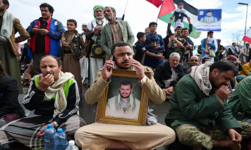 A Houthi supporter holds a poster with an image of the Houthis&rsquo; leader Abdul Malik Al Houthi during a demonstration in solidarity with Iran in Sanaa, Yemen. &ndash; Reuters