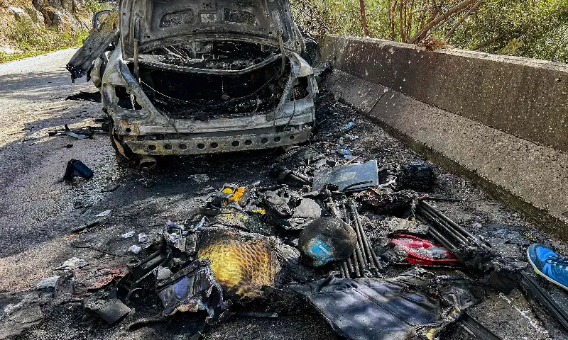 Gear that was used by a media crew of journalists who were killed in an Isareli strike earlier is displayed near the husk of their destroyed vehicle along the side of a road leading to Jezzine in southern Lebanon on March 28, 2026. AFP