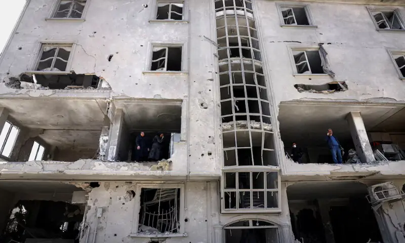 People inspect damage to a residential building after it was hit by a strike in Tehran, Iran. &ndash; Reuters
