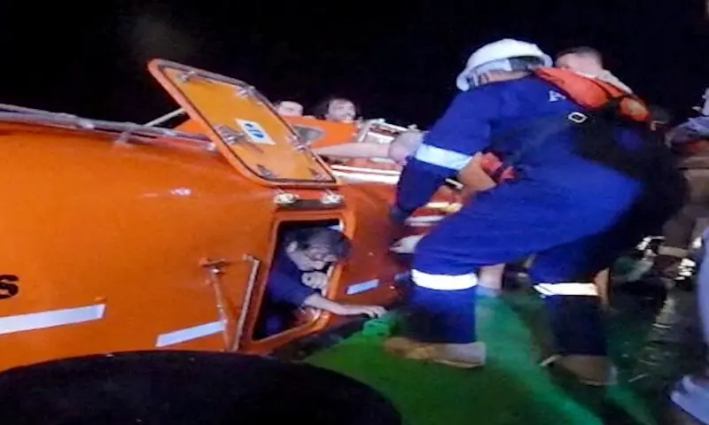 A rescuer guides a man out of a lifeboat after Iranian explosive-laden boats attacked two fuel tankers in Iraqi waters. &ndash; Reuters