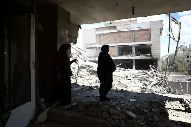 A woman stands in her brother&rsquo;s home, which was damaged by a strike, as the U.S.-Israeli conflict with Iran continues, in Tehran, Iran. &ndash; Reuters