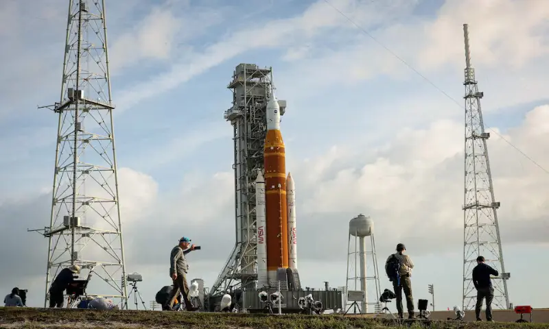 People set cameras to photograph NASA&rsquo;s Artemis II lunar flyby mission, with the next-generation moon rocket, the Space Launch System (SLS) rocket and the Orion crew capsule, on Pad 39B, ahead of the launch of the Artemis II mission at the Kennedy Space Centre in Cape Canaveral, Florida, US, on March 31, 2026. Reuters