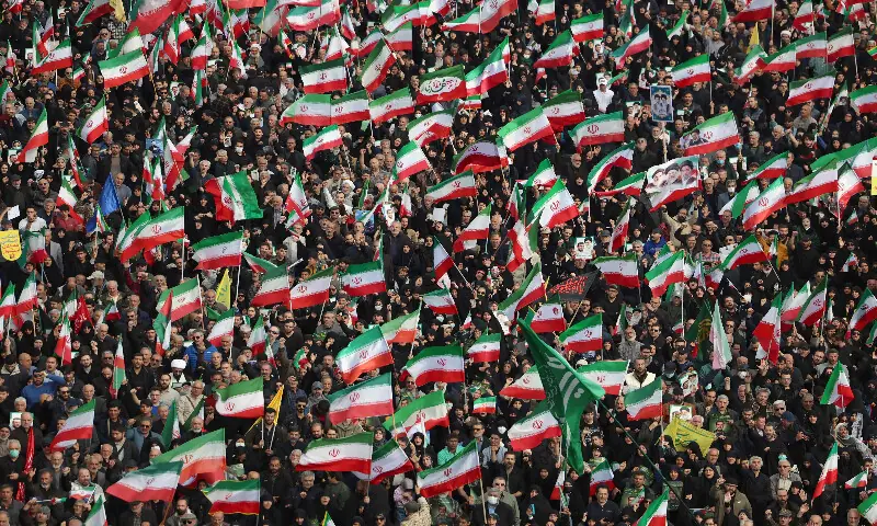 People wave Iranian flags while attending the funeral of Alireza Tangsiri, commander of the Iranian Revolutionary Guards&rsquo; navy alongside others killed in US-Israeli strikes on Iran at Enghelab Square in Tehran on April 1, 2026. AFP