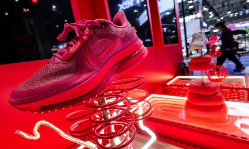 A man walks past Nike booth with an installation of shoes at the 8th China International Import Expo (CIIE) venue in Shanghai, China. &ndash; Reuters