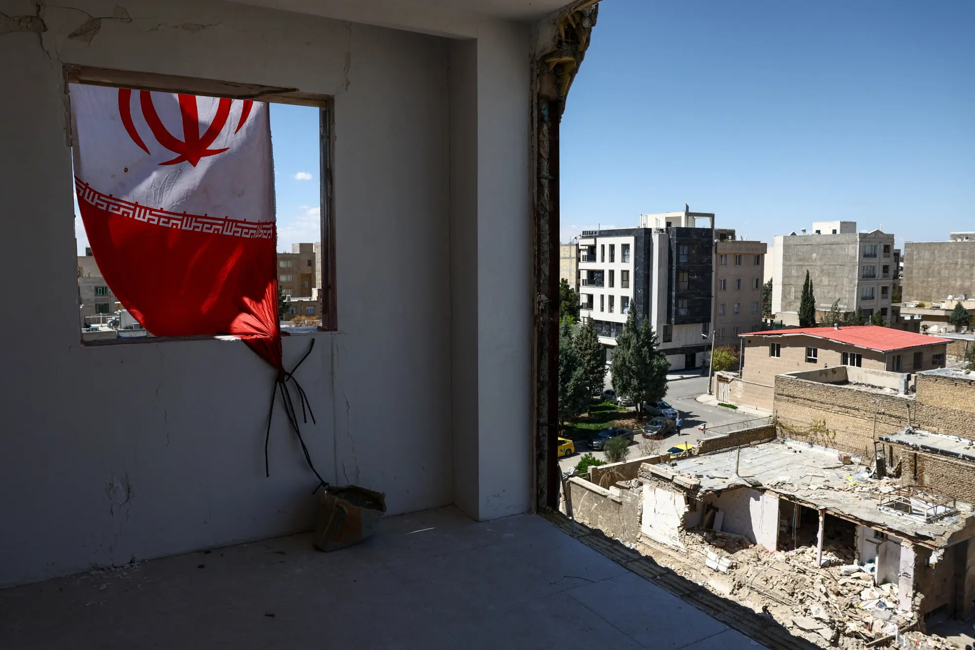 An Iranian flag at a residential building damaged by a strike, amid the US-Israeli conflict with Iran, in Karaj, Iran. &ndash; Reuters