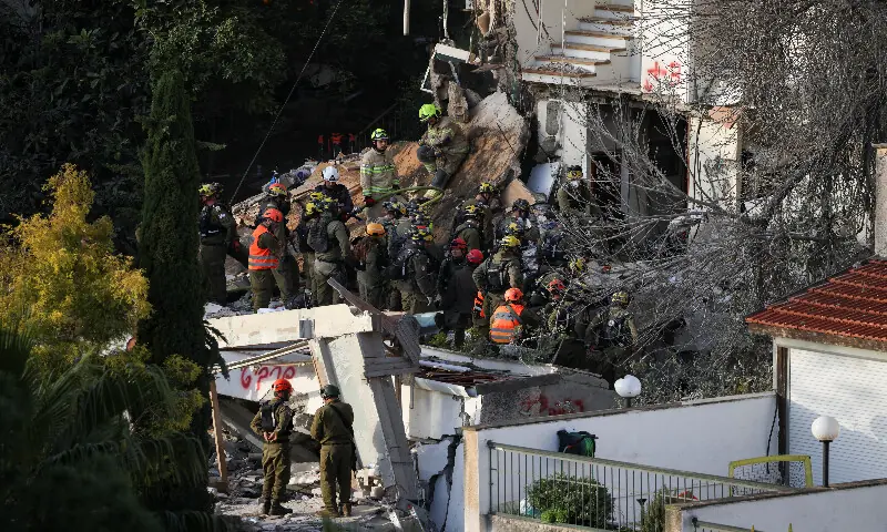 Emergency personnel work at the site of a projectile impact in Haifa, Israel, on Monday. &ndash; Reuters
