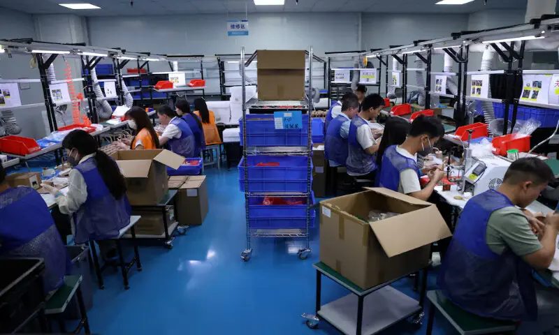 Employees work on a production line manufacturing electronic products at a factory of Agilian Technology in Dongguan, Guangdong province, China. &ndash; Reuters