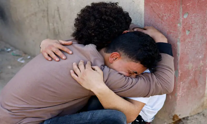 Palestinians react following an Israeli strike outside a school sheltering displaced people at Al Aqsa Martyrs Hospital in Deir Al Balah in the central Gaza Strip. &ndash; Reuters