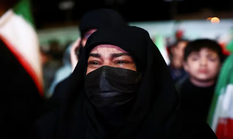 A woman reacts as people gather after a two-week ceasefire in the Iran war was announced in Tehran, Iran, on Wednesday. &ndash; Reuters