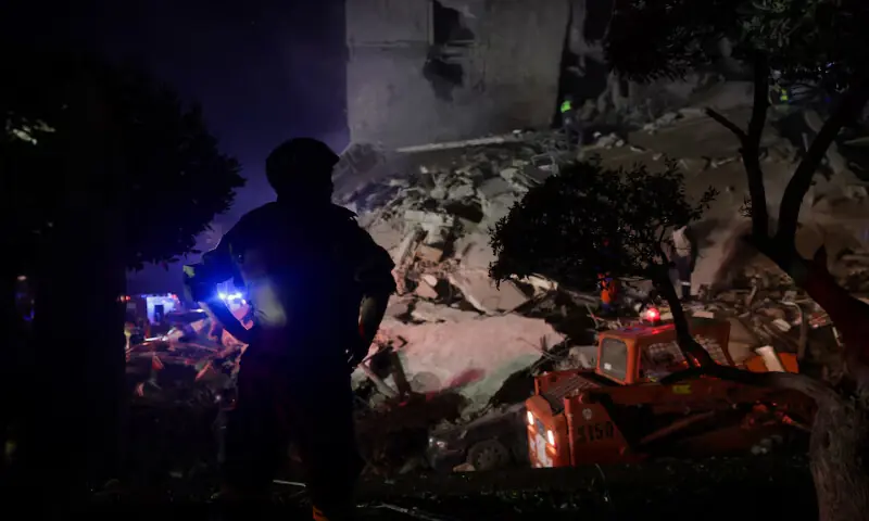 A rescuer looks on as others save people from a damaged building following an Israeli strike, in Beirut, Lebanon. &ndash; Reuters