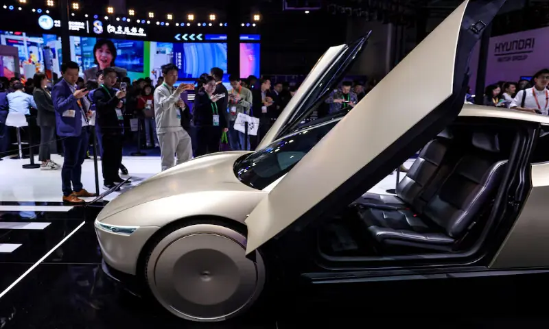 People take images of Tesla Cybercab at the company&rsquo;s booth at the 8th China International Import Expo in Shanghai, China, on November 6, 2025.Reuters file