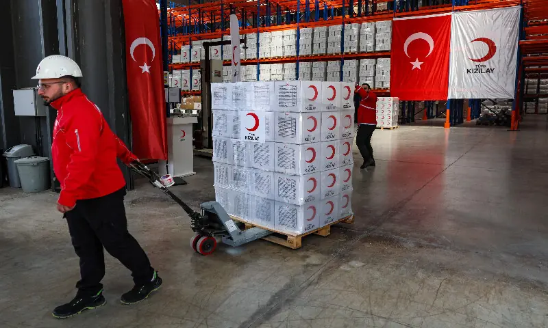 Workers handle aid cardboard boxes in Ankara on April 10, 2026 as The Red Cross and Turkey&rsquo;s Red Crescent plan to send supplies in Iran. AFP