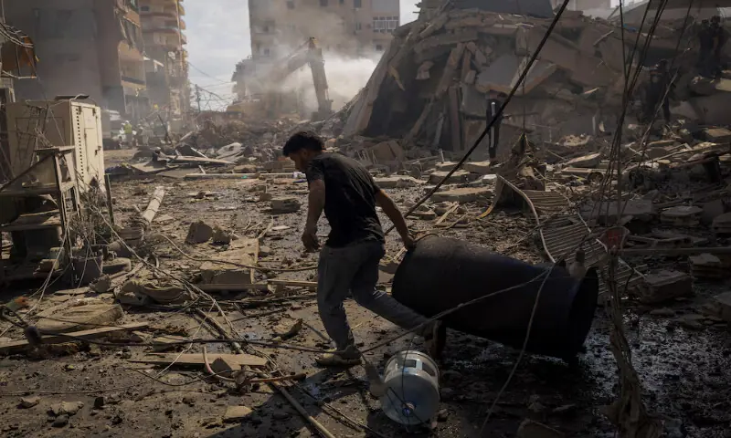 A man pulls a drum at the site of an Israeli strike in Tyre, Lebanon,. &ndash; Reuters