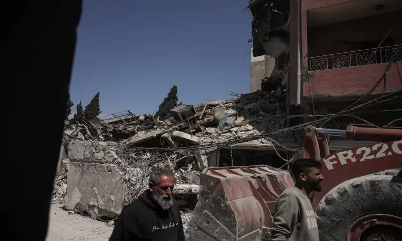 A bulldozer works at the site of Israeli strike, in Tyre, Lebanon. &ndash; Reuters