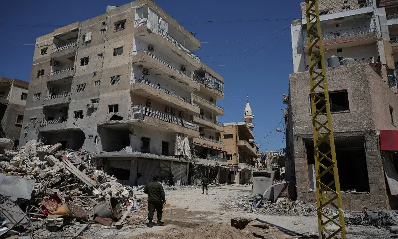 A municipality police officer walks in an area damaged during Israeli strikes in Tyre, south Lebanon. – Reuters A municipality police officer walks in an area damaged during Israeli strikes in Tyre, south Lebanon. – Reuters
