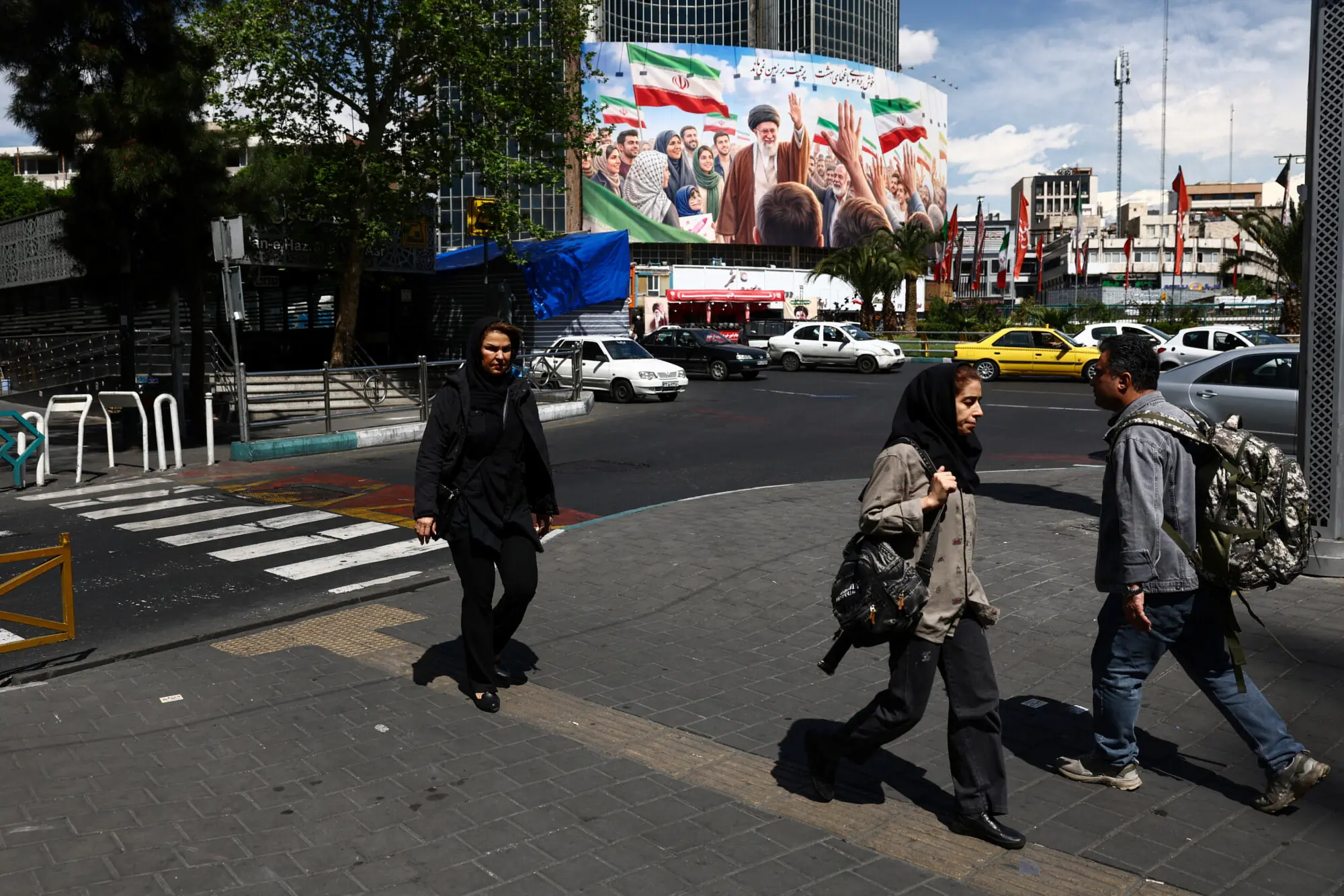People walk past a billboard featuring an image of the late Supreme Leader of Iran, Ayatollah Ali Khamenei, on a building in Tehran, Iran. – Reuters file People walk past a billboard featuring an image of the late Supreme Leader of Iran, Ayatollah Ali Khamenei, on a building in Tehran, Iran. – Reuters file