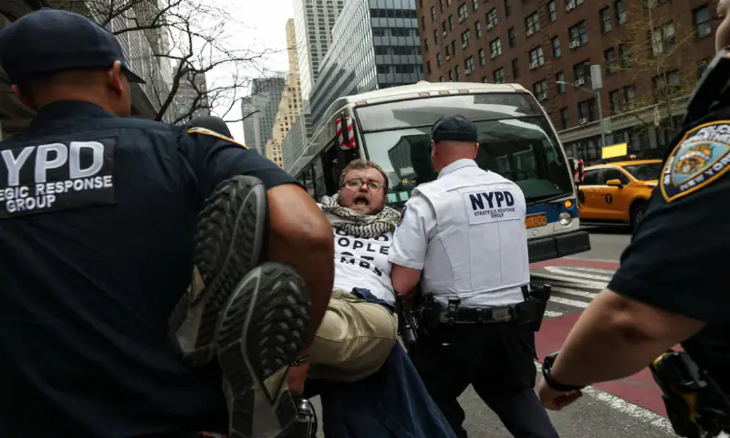 NYPD officers detain a demonstrator during a protest along Third Avenue in the Midtown area of New York City, US. &ndash; Reuters