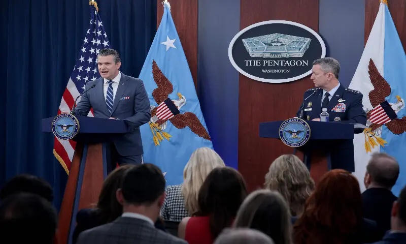 US Secretary of War Pete Hegseth speaks as Chairman of the Joint Chiefs of Staff Gen. Dan Caine listens during a press briefing at the Pentagon on April 16, 2026 in Arlington, Virginia. AFP