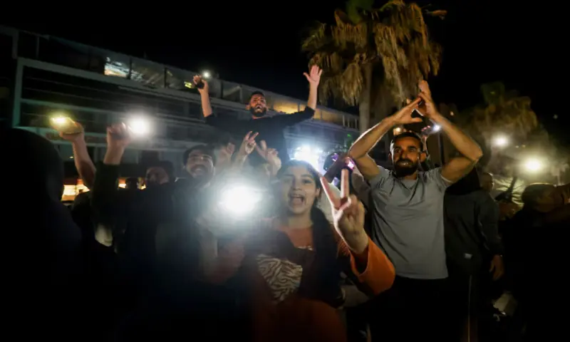 A crowd celebrates as displaced people return to their homes after a 10-day ceasefire between Lebanon and Israel went into effect, in Sidon, Lebanon. &ndash; Reuters